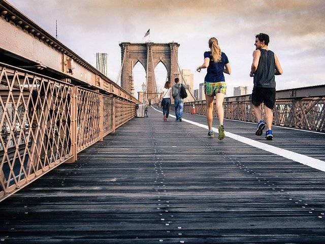 Two friends jogging on the street showing a platonic friendship
