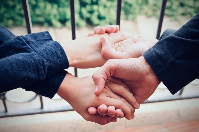 Two friends holding hands